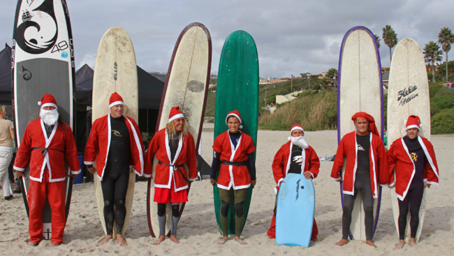 Surfers Dress Like Santa to Raise Money for Children with Autism