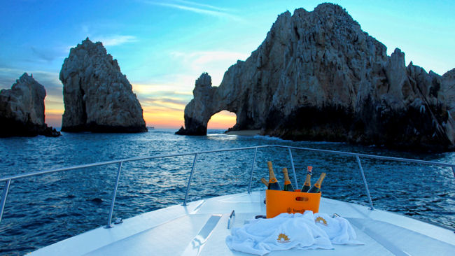 yacht at Cabo arch sunset