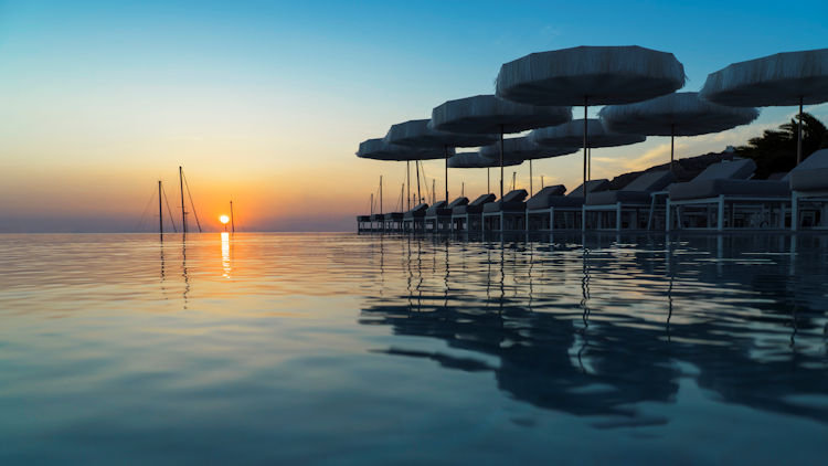 Sunset over the swimming pool of the Mykonos Riviera