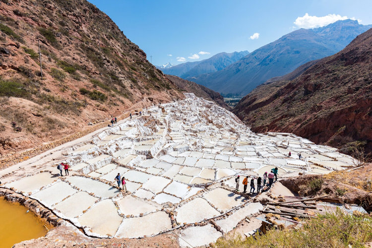 Hundreds of white salt pools stepping down a valley at Maras